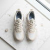 On Cloud white running shoe flat lay white marble